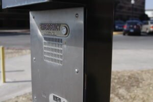 To begin a call on an emergency telephone box, hold the button down for two seconds before directly speaking into the call box.