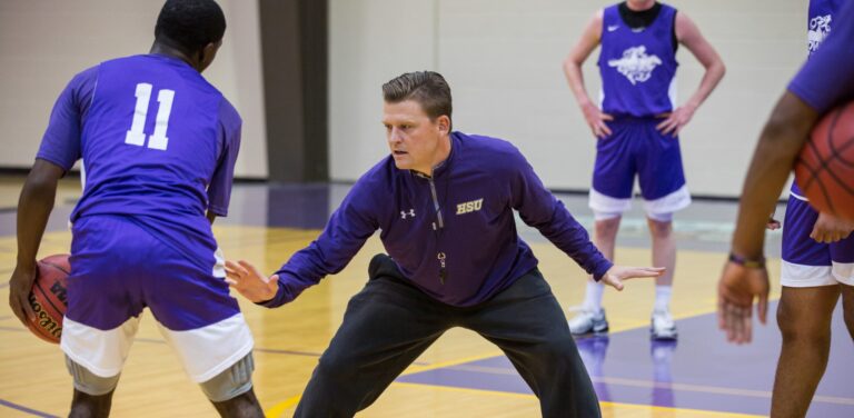 Basketball coach instructing players
