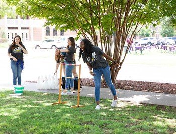 Students play frisbee at Cowboy Connect.