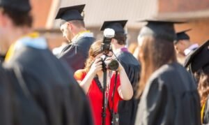 A photographer takes photos at graduation.