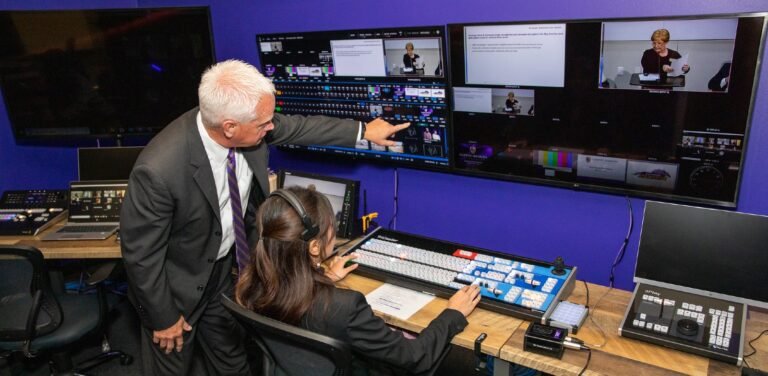 A professor advising a student in the digital media studio.