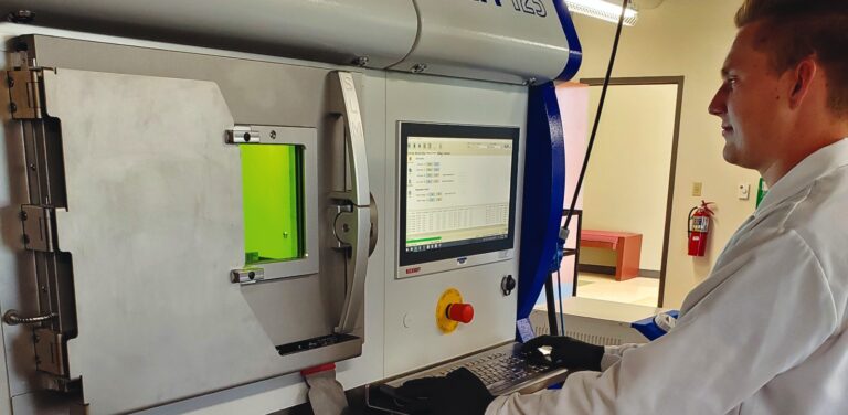 Student working on a machine in an engineering lab.