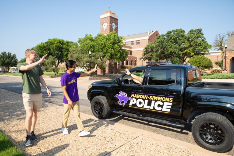Students with HSU Police vehicle