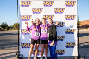Students pose with their Turkey Day 5K medals.