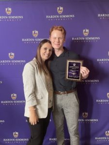 Megan McKinney and Karson Gopffarth posing with his 2021-2022 Cowboy of the Year Award.