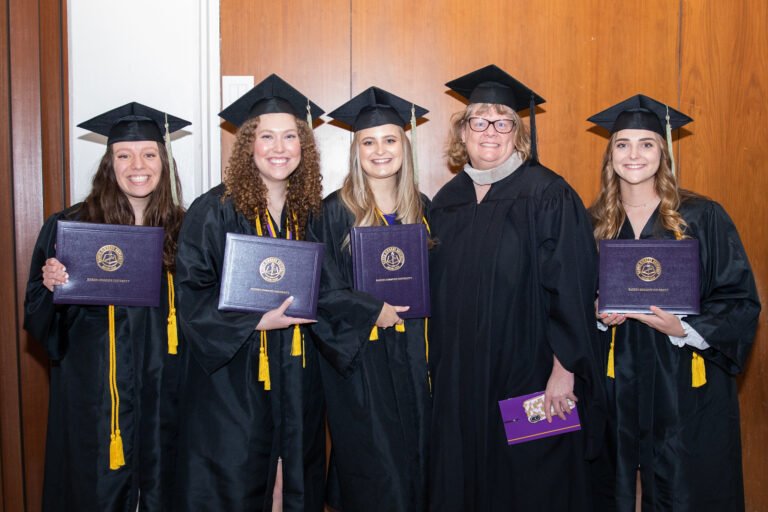 CSD graduates stand with their professor, Becky Saterbak.