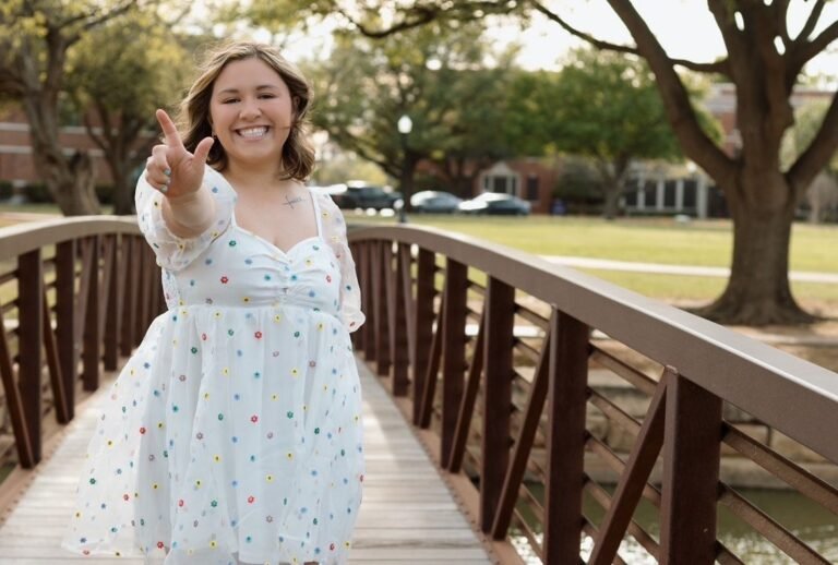 Kailey Valadez posing on the campus bridge.