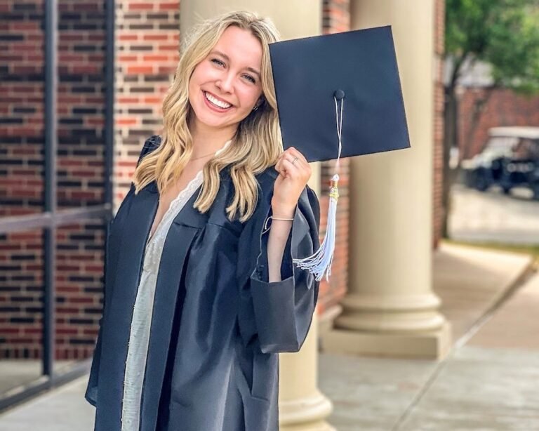 Kaylin Bouse posing with her graduation cap