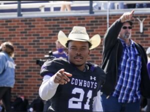 Demarcus wearing a cowboy hat in his football uniform