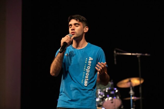 Elijah Arias, a member of chapel band, can be seen here singing.