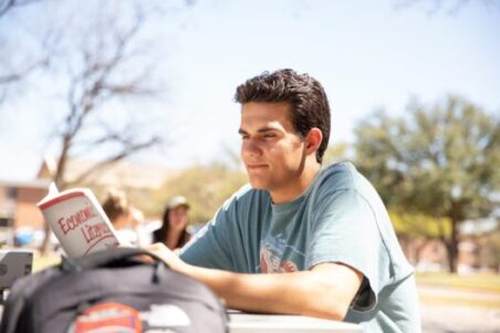 A student studying outside the library