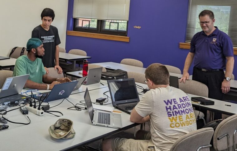 Computer science students working on computers.