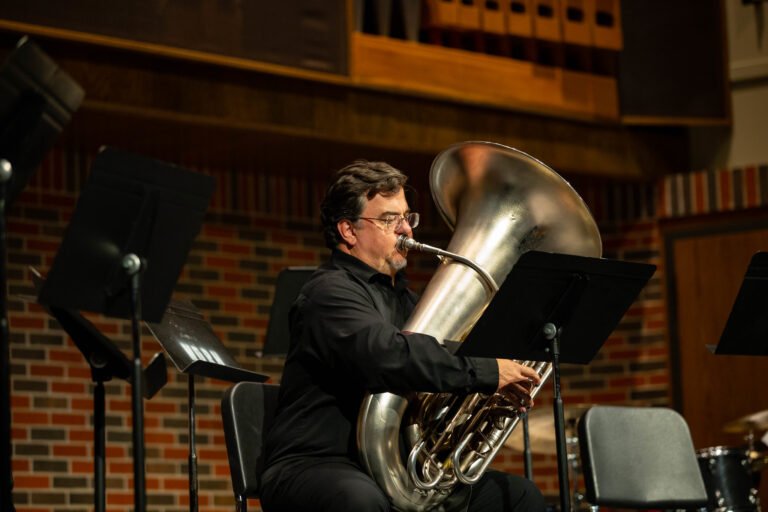 Dr. Cottrell playing the tuba during a former concert.