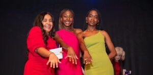 Three female students show of their rings at Ring Ceremony