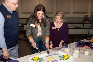 HSU employees Chastity Jobe, Dr. Lauren Cantrell, and Dr. Larry McGraw enjoy cake during the reception. 