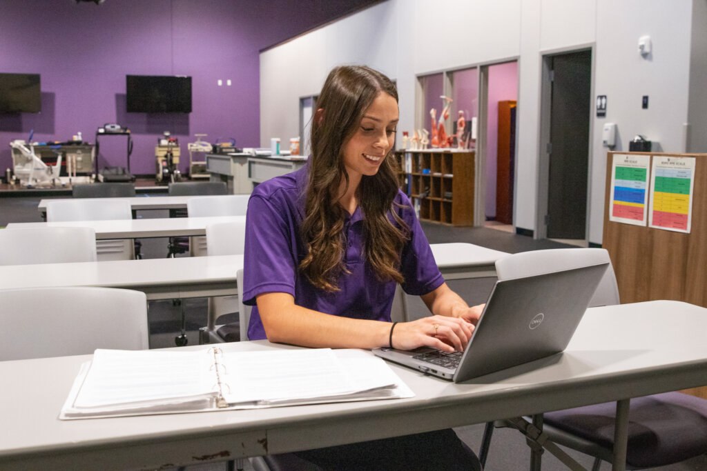 Graduate Student typing on a laptop