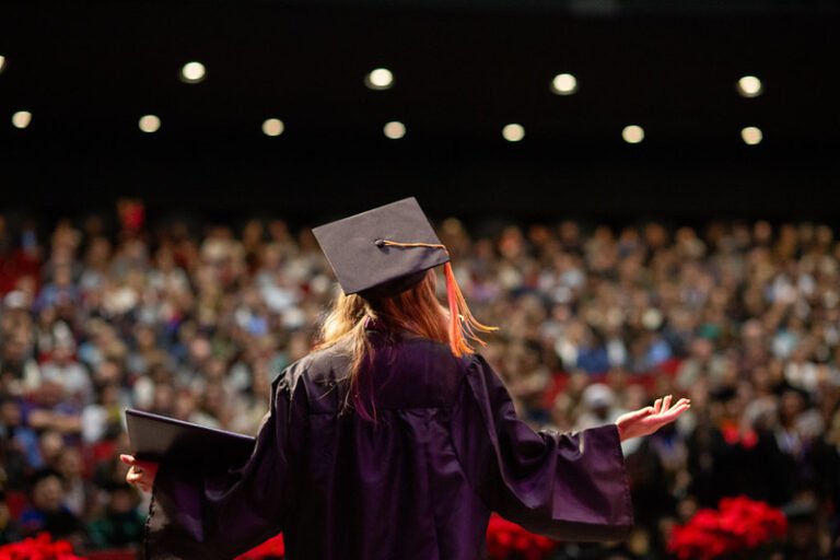 A graduate looks out to the crowd during commencement ceremonies.