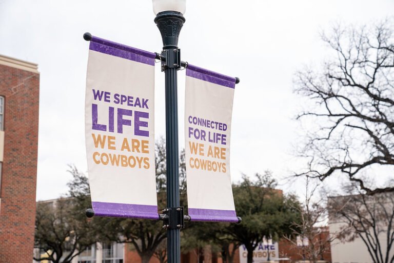 Campus banners say, "We speak LIFE, We are COWBOYS."