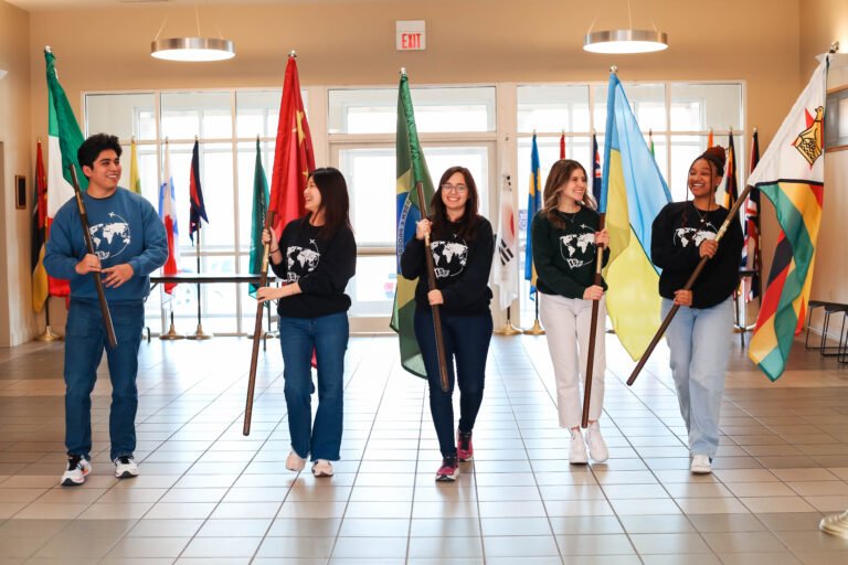 The 2023-2024 ISF officers holding the flags of their home countries.