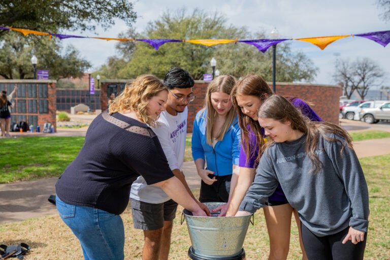 HSU Sophomores dunking for rings together, an age-old HSU tradition.