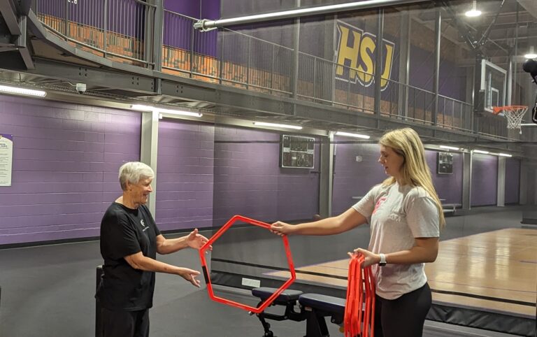 Ava Dennis and Dr. Lorraine Wilson go through a balance and stabilization exercise.