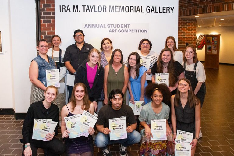 Student artists pose with their awards after the student art show.