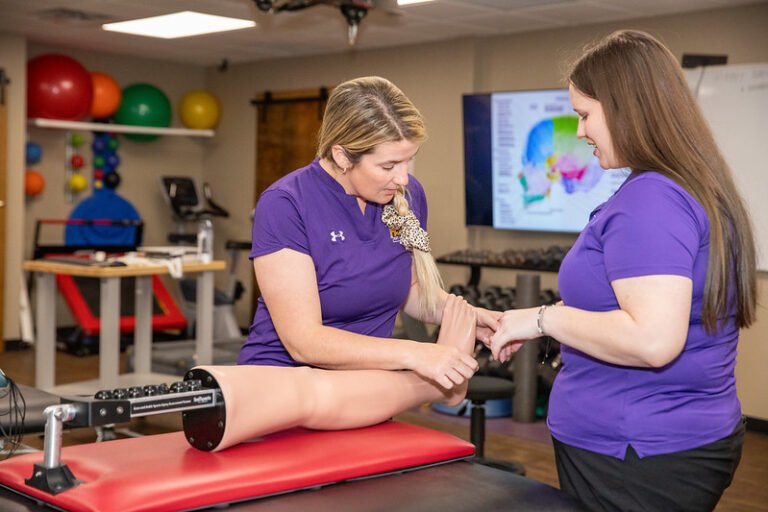 MAT students practice on a simulated limb.