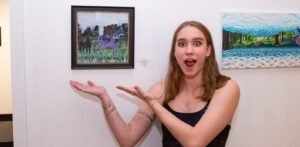 A student shows off her art project.