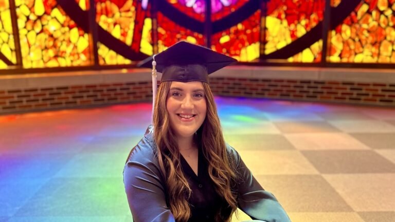 Lainey Burleson sits in Logsdon Chapel with her graduation cap.