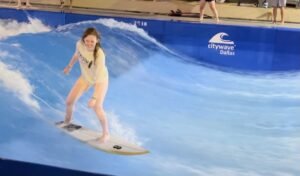 Mandy Jo is surfing in a pool. 