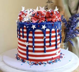 A patriotically decorate cake with red, white, and blue icing. 