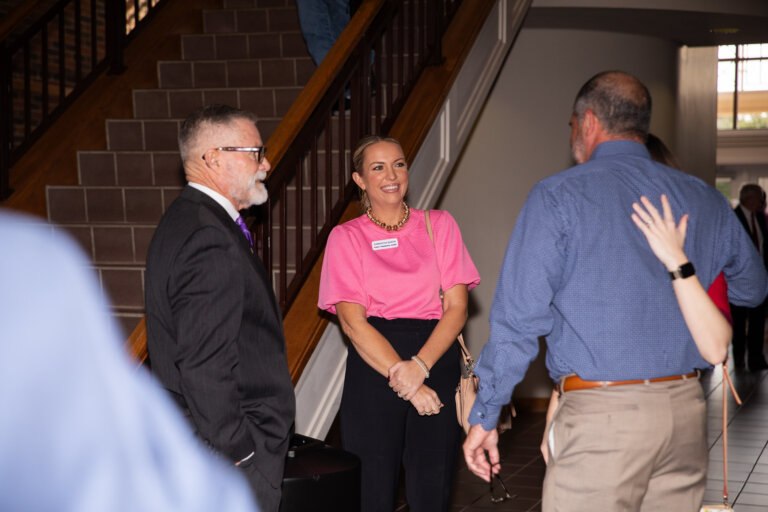 Businessmen and women networking at the Ray Lewis Lecture
