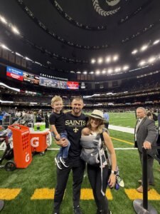 Luke Lancaster, Hardin-Simmons University alumnus and New Orleans Saints assistant strength and conditioning coach, poses for a photo with his family. 