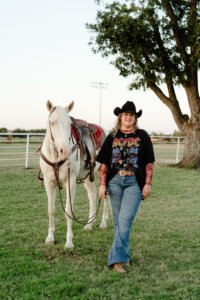 Kate Voss with one of the iconic Six White Horses — a historic Hardin-Simmons University equestrian tradition. Despite having almost no riding experience when she arrived at HSU, Kate earned a place on the team through determination and the program’s supportive training.