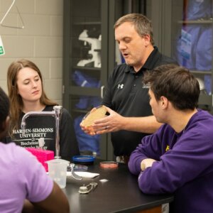 Biology Class, Teacher showing petri dish