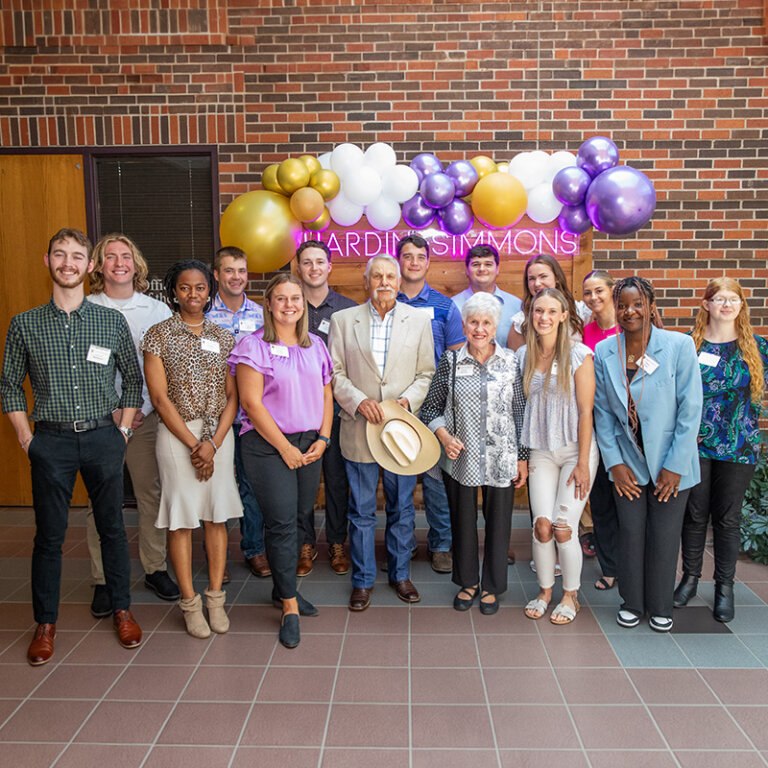 Newmans at the Scholarship Luncheon having their photo taken with their students