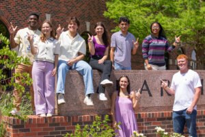 Group of students on the HSU Sign