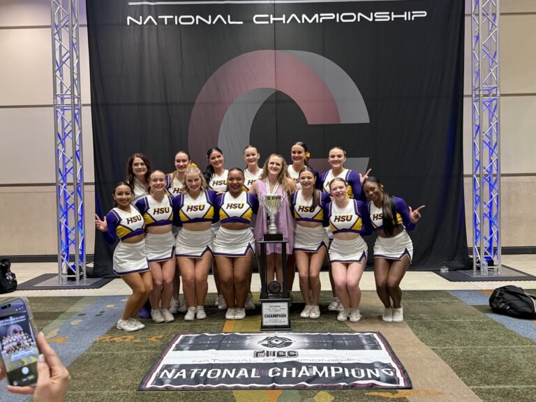 HSU Cheer posed smiling for the national cheer competition at the airport