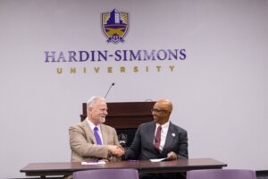 HSU and Ranger college representatives signing an articulation agreement shaking hands