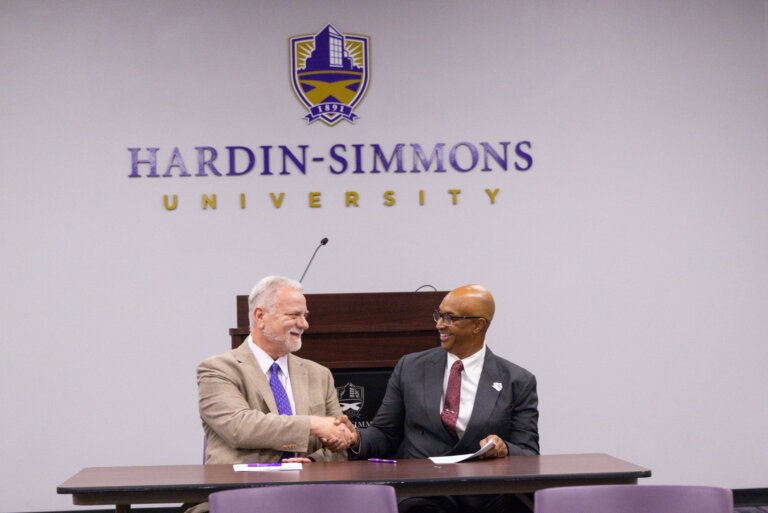 HSU and Ranger college representatives signing an articulation agreement shaking hands