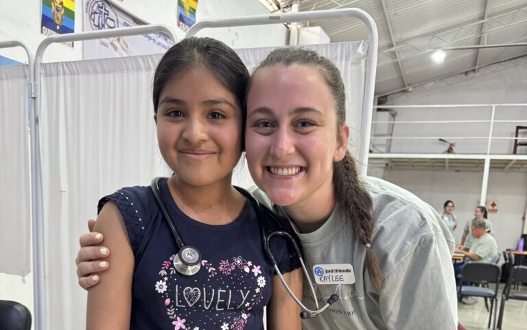 PA Student on a mission trip to Peru posing with a girl