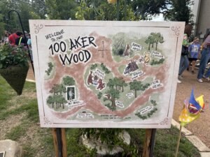 Sign of the 100 Aker Woods in a garden.