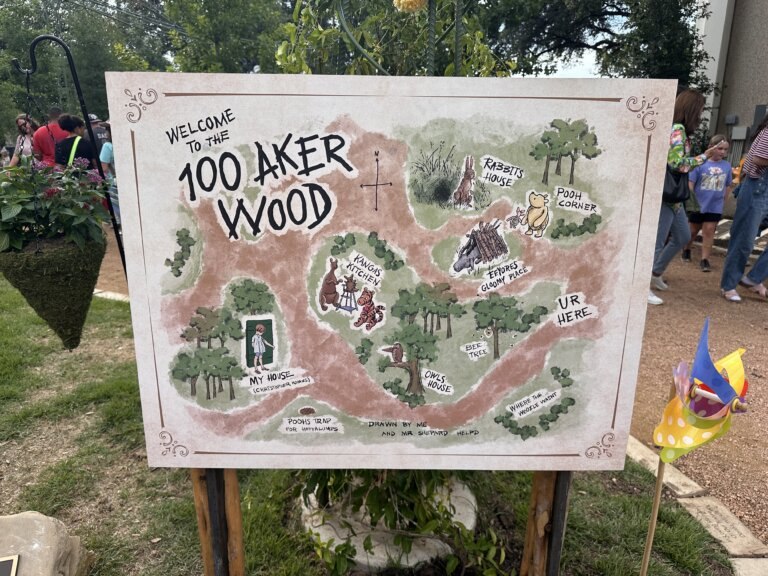 Sign of the 100 Aker Woods in a garden.