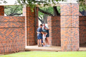 Family praying together on campus