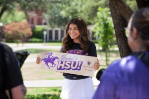 girl at hsu holding up a sign