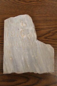 Broken marble headstone for Dam-it